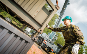Vojáci při manipulaci s kontejnerem využívají přesnost a stabilitu jeřábu Liebherr.