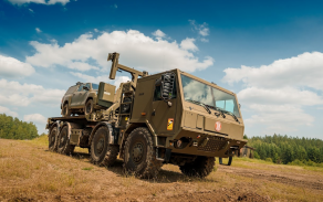 Vojenská Tatra 815-7 8×8 hákový nakladač s kontejnerem v terénu.